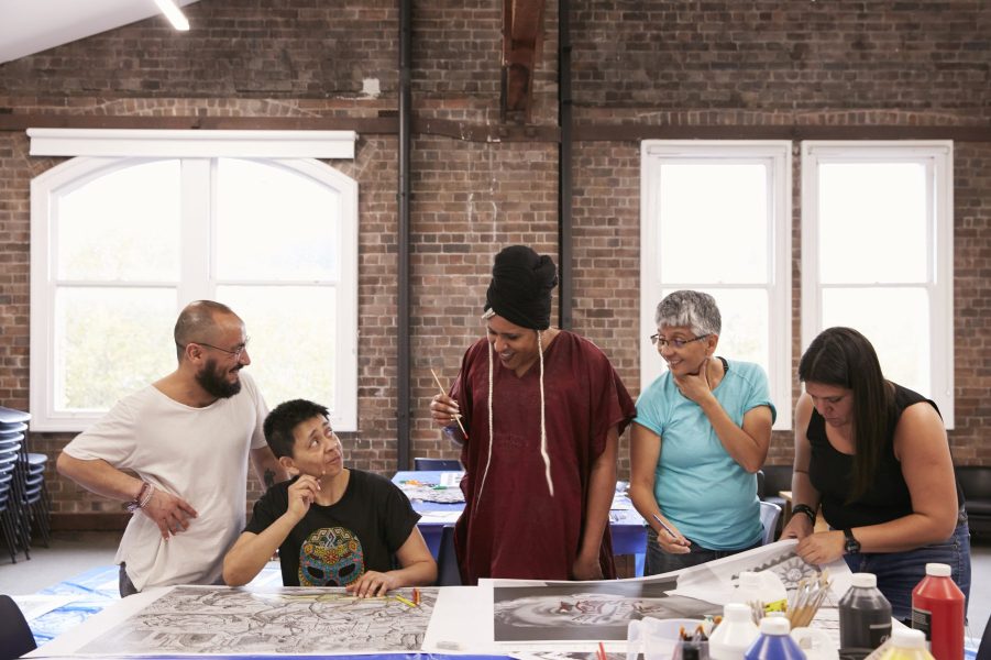 This image depicts all five members of Colectivo Ayllu working together on their installation 'don't blame us for what happened'.