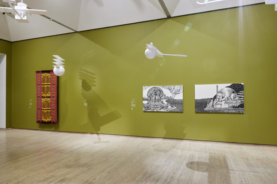 Left to right: Iratxe Jaio and Klaas van Gorkum, False Flag, 2021-23. Commissioned by the Biennale of Sydney with generous assistance from the Mondriaan Fund, the Etxepare Basque Institute and assistance from Accion Cultural Español. Courtesy the artists. © Iratxe Jaio & Klaas van Gorkum. Magdalena Meak, Tais mane (Men’s ceremonial cloth), 2022. Courtesy the artist © Magdalena Meak. Sachiko Kazama, Pavilion – Earthly Fart, 2020. Commissioned by the Biennale of Sydney with generous support from the National Center for Art Research, Japan; Pavilion – White Elephant (MONJU), 2020. Courtesy the artist and MUJIN-TO Production © the artist and MUJIN-TO Production. Installation view, 24th Biennale of Sydney, Ten Thousand Suns, 2024, Art Gallery of New South Wales. Photograph: Christopher Snee.