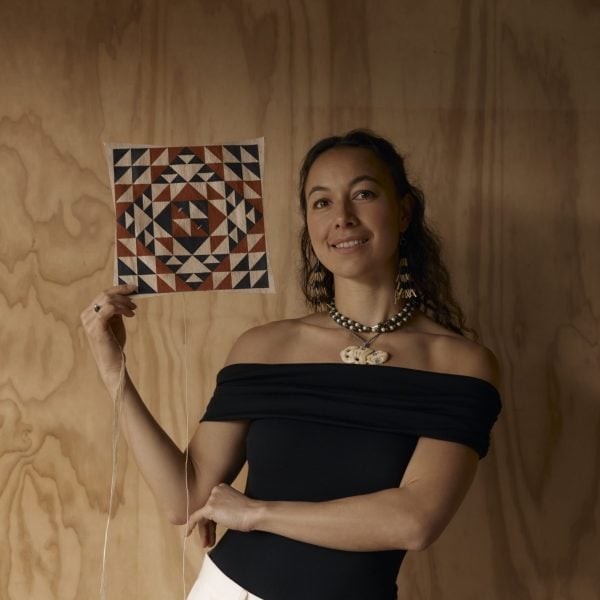 Nikau Hindin holding a manu aute, Māori kite, in her studio. Photo: Holly Burgess.