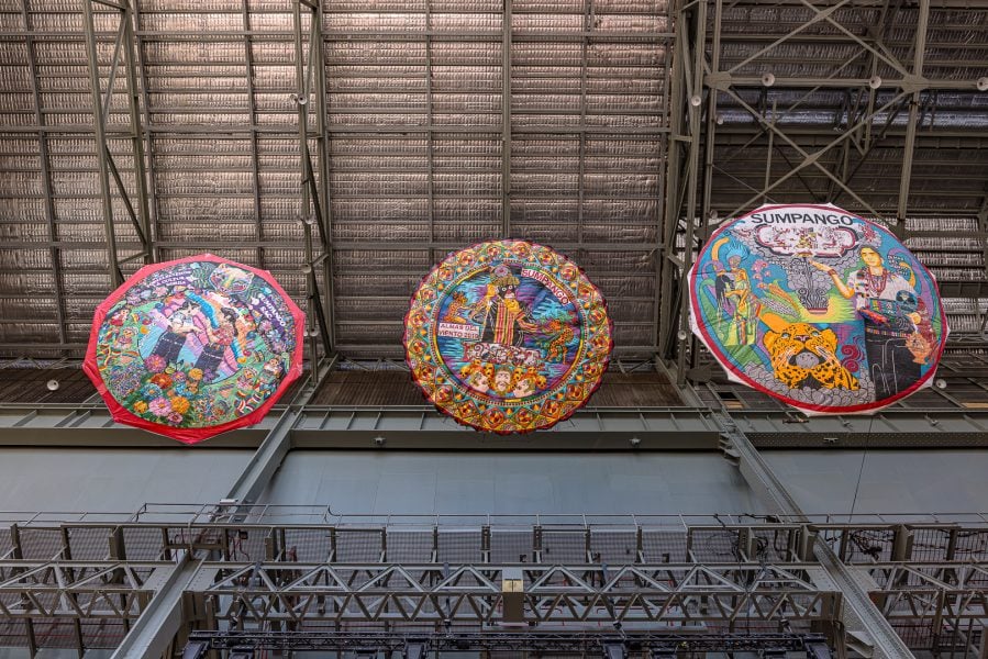 Left to right: Orquídeas Barrileteras, Strengthening Deaf Culture (detail), 2023. Commissioned by the Biennale of Sydney and the Fondation Cartier pour l’art contemporain. Courtesy the artists © Orquídeas Barrileteras. Barrileteros Almas Del Viento, El danzante (The Dancing one), 2019; Resurreccion del Maiz (Resurrection of the corn), 2017. Courtesy the artists © Barrileteros Almas Del Viento. Installation view, 24th Biennale of Sydney, Ten Thousand Suns, 2024, White Bay Power Station. Photograph: Document Photography.