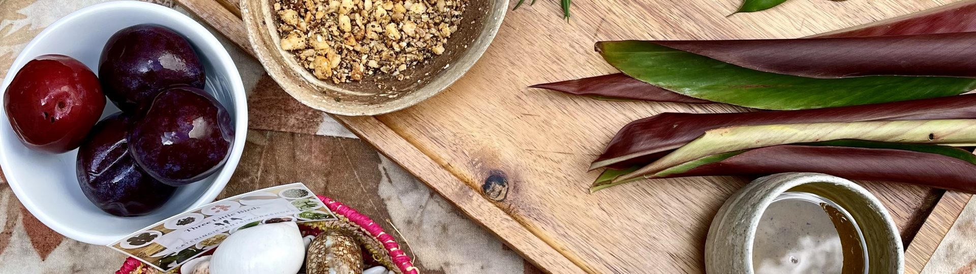 A spread of native ingredients in various wood bowls and boards.