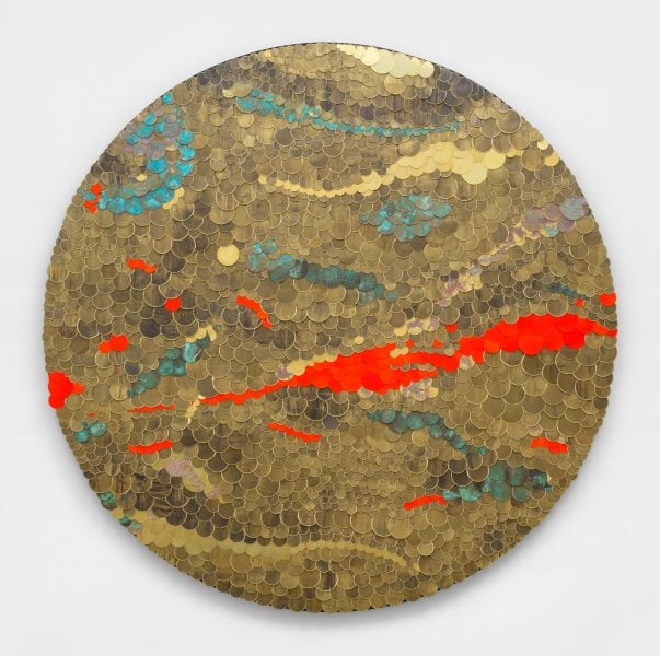 Tuan Andrew Nguyen, Scars, 2025, Pounded brass from artillery shells, enamel paint, patina, acrylic, plywood, metal, 200cm diameter. Photograph: Dan Bradica. Courtesy of the artist and James Cohan, New York. Copyright © Tuan Andrew Nguyen, 2025.